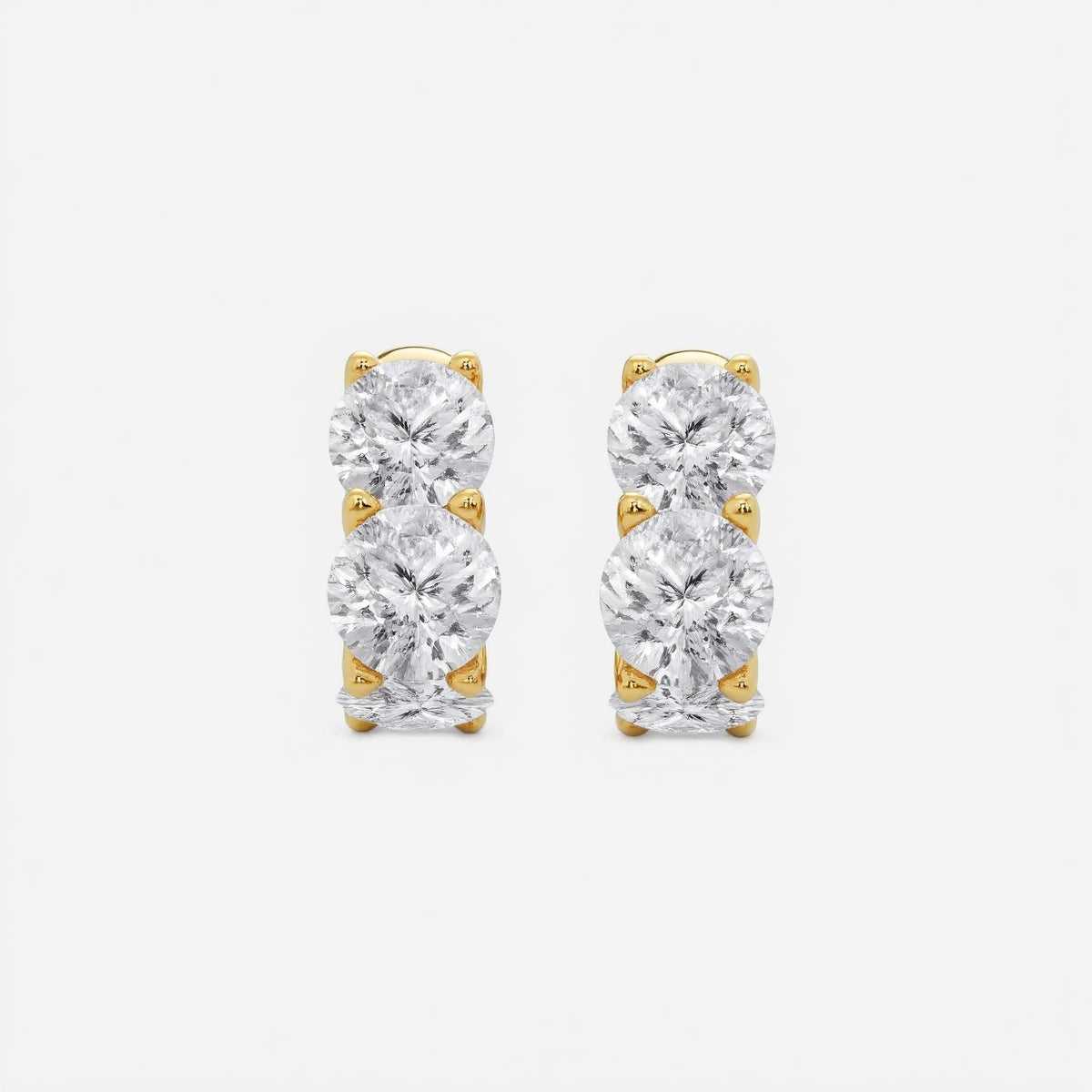 Our Cushion Lab Grown Diamond Huggie Hoop Earrings by Adorn By You, beautifully crafted in radiant yellow gold. Featuring three brilliant lab-grown diamonds per earring and available in 1, 2, and 3 carat options
