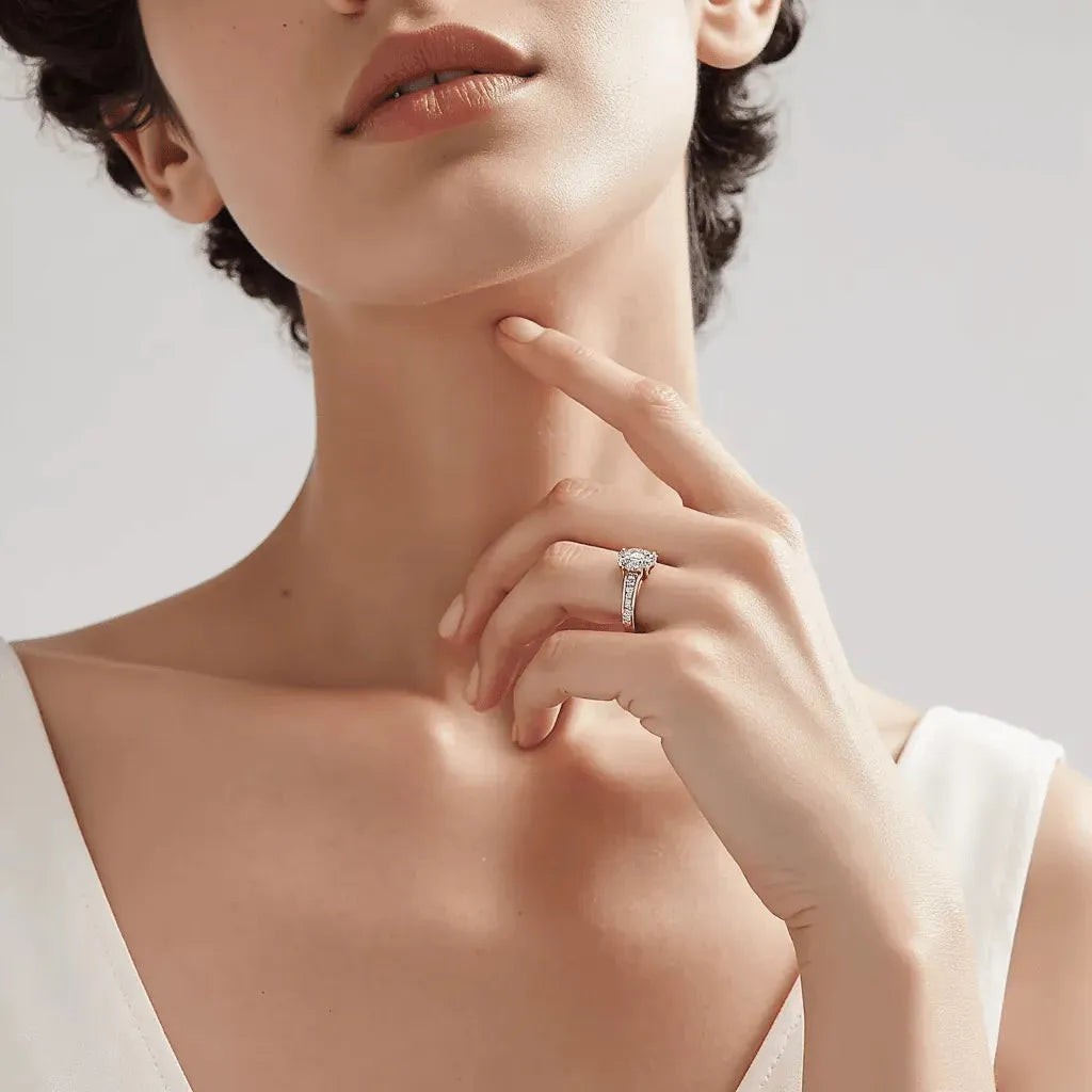 model wearing engagement ring with a channel set diamond band in yellow gold