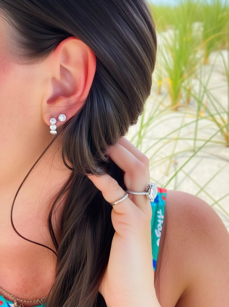 The model wears our Cushion Lab Grown Diamond Huggie Hoop Earrings by Adorn By You, featuring three sparkling lab-grown diamonds in each hoop. Available in 1, 2, and 3 carat options and crafted in 14K or 18K gold.